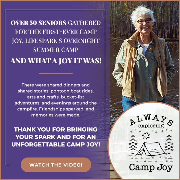 Promo graphic for Camp Joy's senior overnight camp; smiling older woman outdoors beside a circular 'Always Exploring Camp Joy' badge and a 'Watch the Video' button.